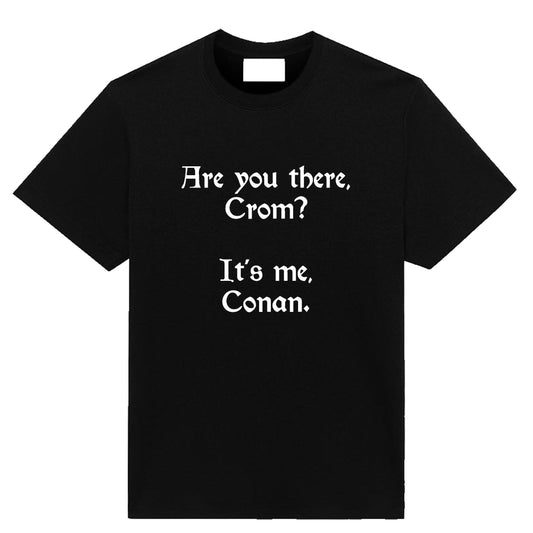 A minimalist fantasy parody T-shirt titled ‘Crom-ulent,’ featuring the line ‘Are you there Crom, it’s me Conan,’ printed on a soft, high-quality tee